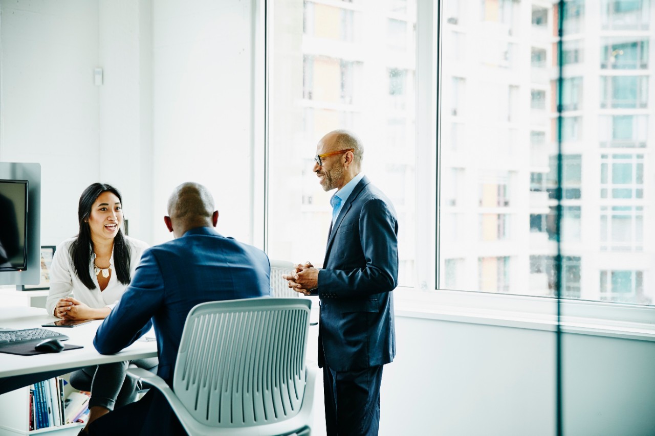 Business colleagues discussing project in office conference room