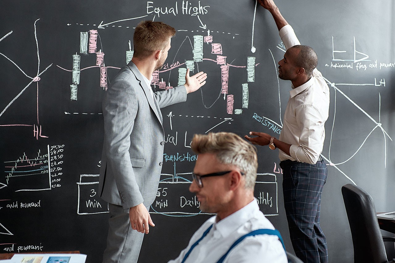 A passion to perform. Businessmen, traders in shirts discussing strategy and collaborative process in office. Diverse employees working in team on managing and marketing solution.
