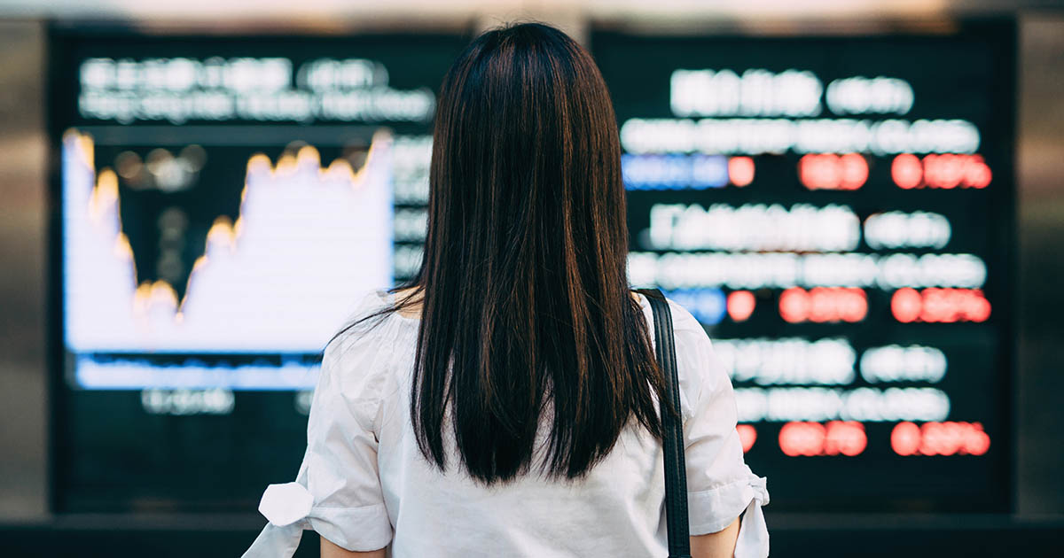 1167016699
Rear view of businesswoman looking at stock exchange market display screen board in downtown financial district