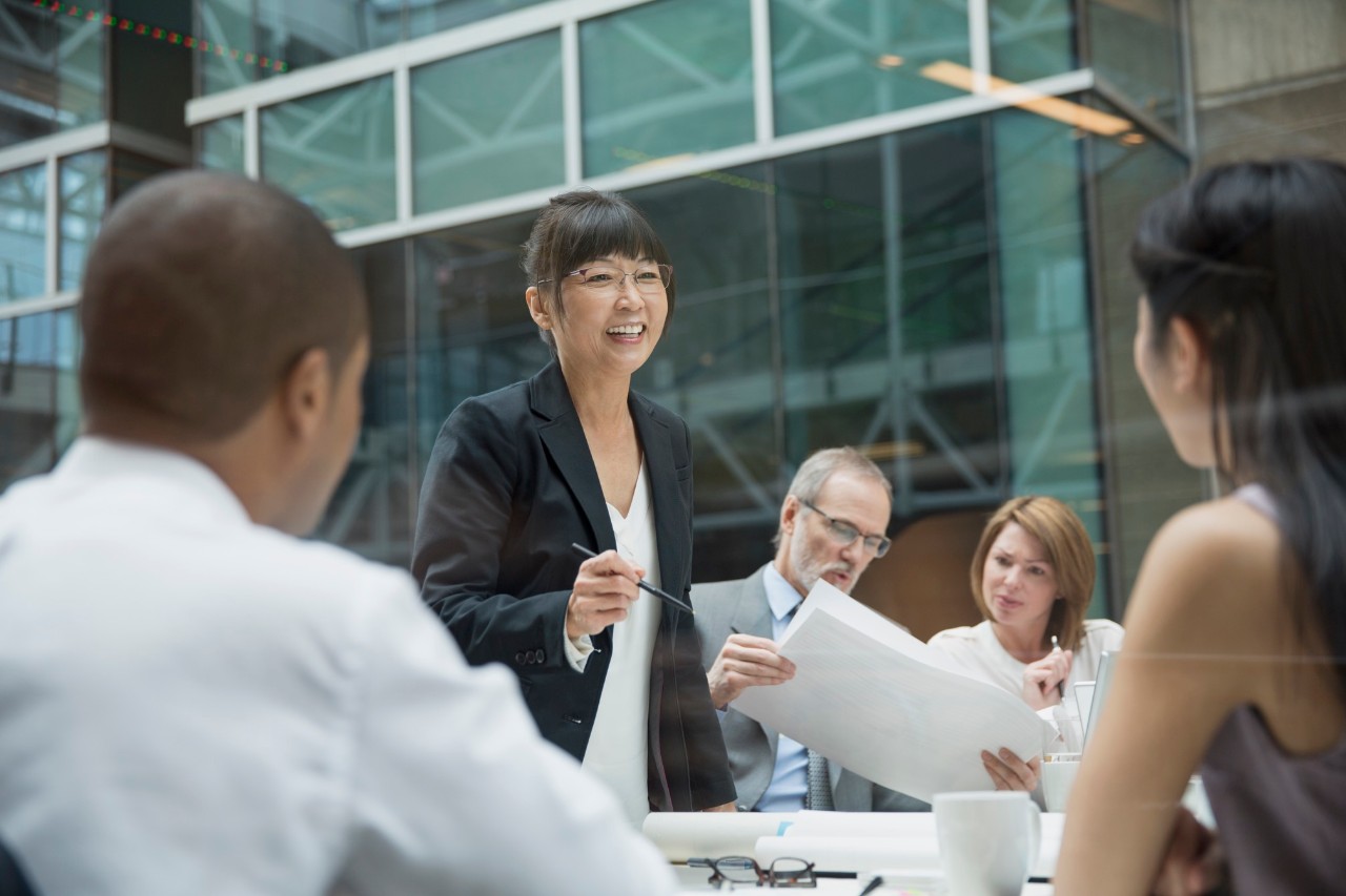 Businesswoman leading meeting in conference room, asian