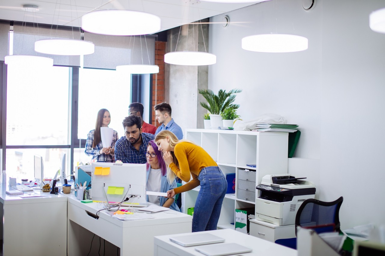 Group of young people in modern office discussing a new project, diverse, computer, laptop